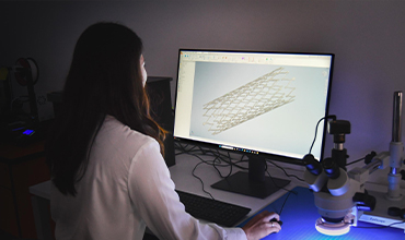 Engineer reviewing medical device design during research and development
